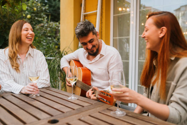 istock Friends having fun playing a guitar 2180817948