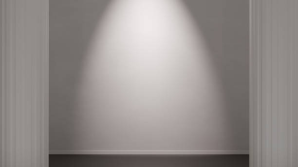 White wall lit by a spotlight, in a minimalist environment with classic columns