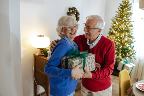 istock Elderly couple sharing a warm embrace during Christmas 2180825234