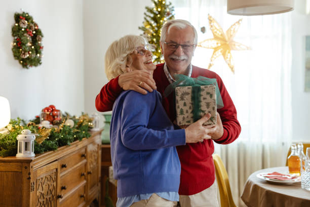 istock Elderly couple sharing a warm embrace during Christmas 2180826169
