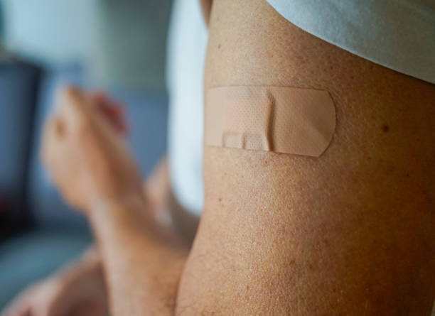 istock Men's arm with band-aid plaster 2180826306