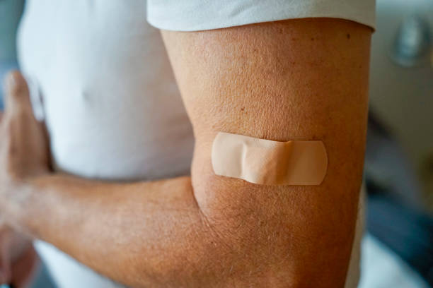 istock Men's arm with band-aid plaster 2180826314