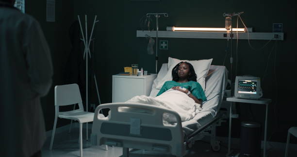 istock African patient rests while the doctor enters with a folder 2180827741