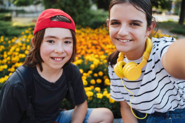 istock Youngsters enjoying selfie amidst colorful blooms 2180831438