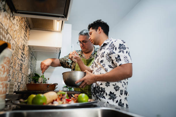 istock Gay couple cooking together in modern kitchen 2180848639