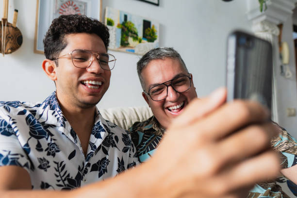 istock Two men having fun taking a selfie at home 2180848641