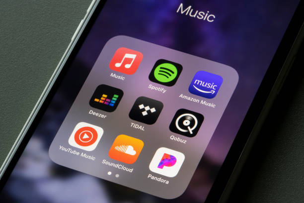 Assorted Music Apps Portland, OR, USA - Mar 15, 2021: Assorted music streaming apps, including Apple Music, Spotify, Amazon Music, Deezer, TIDAL, Qobuz, YouTube Music, SoundCloud, and Pandora, are seen on an iPhone. streaming music app stock pictures, royalty-free photos & images