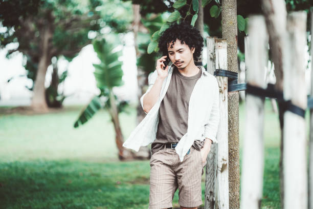 istock Casual man talking on phone outdoors 2180854976