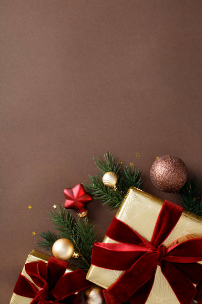 istock Elegant Christmas ornaments, gift boxes, and decorations on dark brown background. Luxury, chic style. Flat lay, top view, copy space. 2180859503
