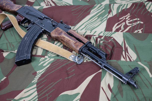 AK assault rifle on camo uniform background