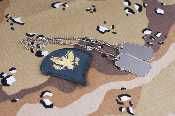 istock US ARMY Specialist rank patch and dog tags on desert camouflage uniform 2180859982