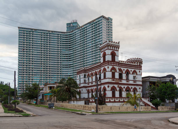 The facade of  a Historical building with a turret and Edificio Focsa in La Habana (Havana), Cuba