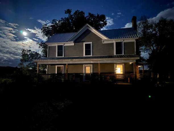 istock A spooky house surrounded by dark trees during a full moon. 2180861895