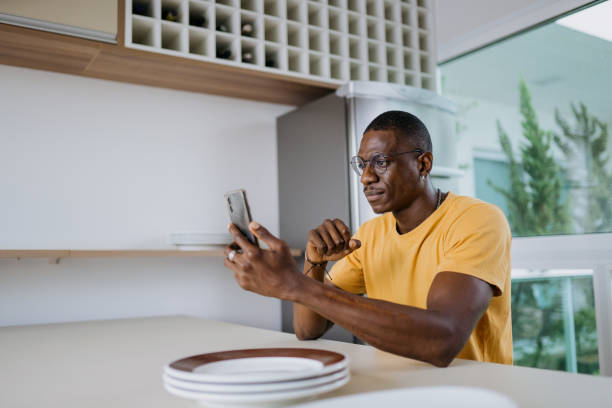 istock Serious man looking at smartphone at home 2180863149