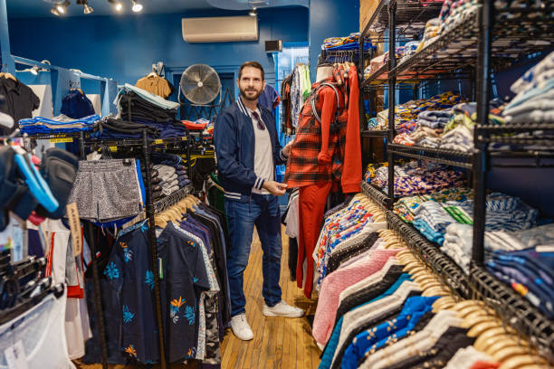 istock Gay man browsing the clothing store 2180872088