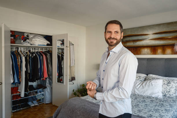 istock Gay man getting dressed  at the city apartment 2180872253