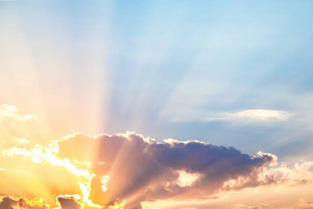 Breathtaking sunrise with radiant sunbeams piercing through clouds, ideal for vibrant and hopeful themes in all creative projects