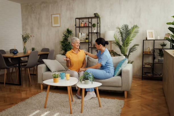 istock Beautiful nurse holding a hand on senior woman's shoulder while discussing 2180889051