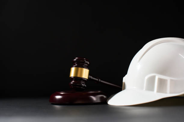istock Hard hat and gavel on black background with copy space. Safety first concept 2180889747