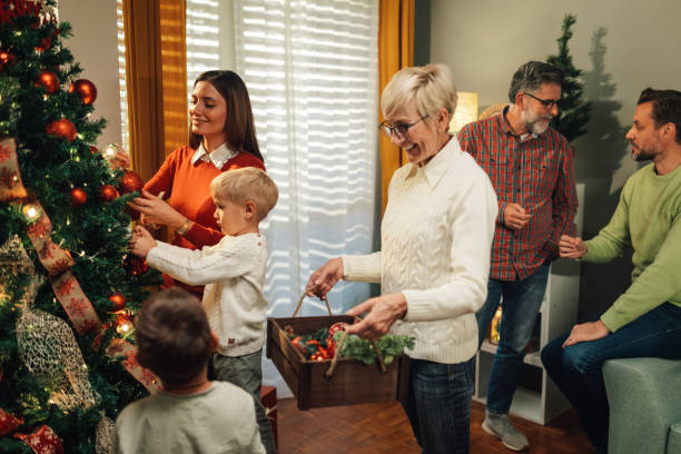 istock Happy family decorating christmas tree at home 2180892376