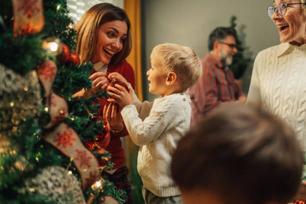 istock Happy family decorating christmas tree together 2180892398