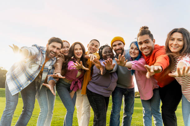 istock Group of diverse people reaching out with open arms 2180892616