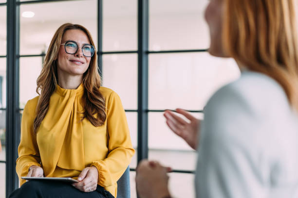 istock Businesswomen talking in the office. 2180893155