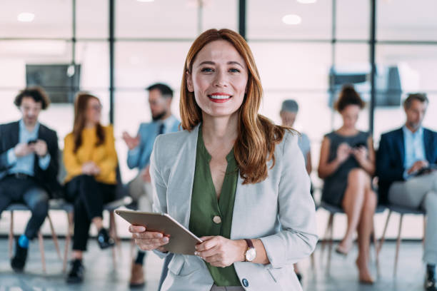 istock Confident businesswoman and her team. 2180893217