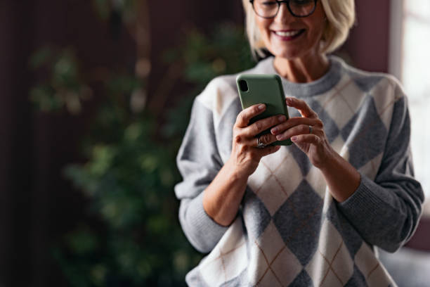 Smiling Woman Engaged With Her Smartphone at Home