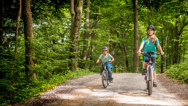 istock Active Caucasian Mother and Child Cycling in Forest 2180896779