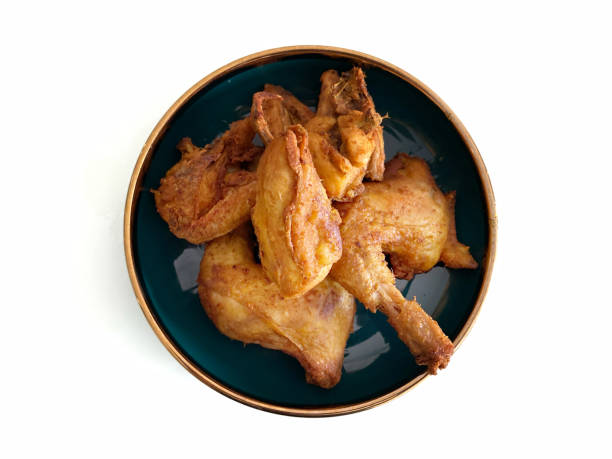 istock Golden brown fried chicken on a green plate, on a white background 2180904230