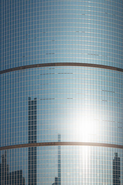 Tall building with multiple windows on a clear blue sky - Financial building wall and Sky. Business Background, Beijing