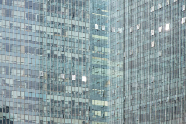 Tall building with multiple windows on a clear blue sky - Financial building wall and Sky. Business Background, Beijing