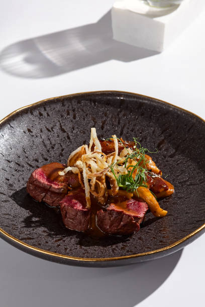 istock Rustic Elegance Beef Tenderloin with Mushroom Sauce on Textured Plate 2180905243