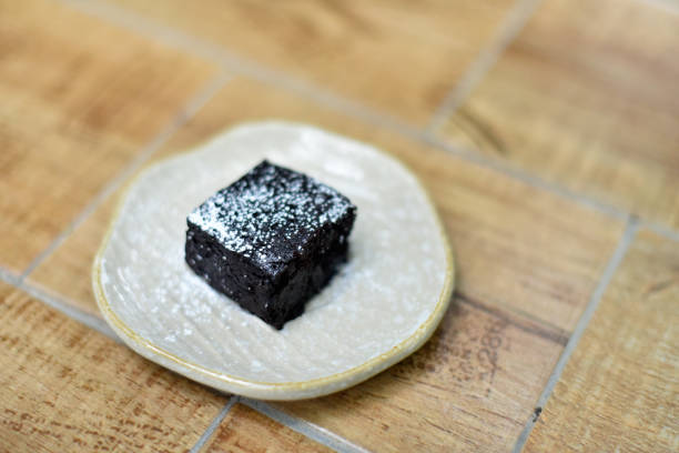 Homemade brownie cake decorated with almond and chocolate.