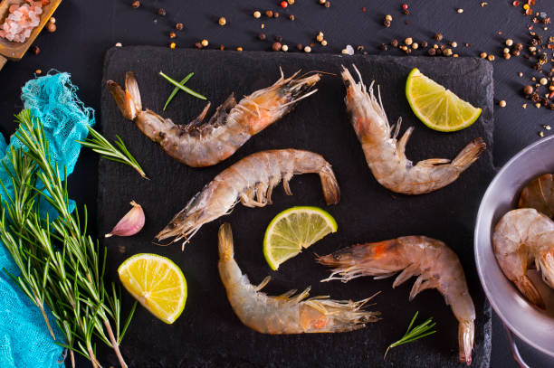 istock fresh tiger Prawns, shrimp seafood with lemon and spices. 2180908428