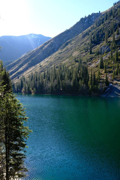 istock Emerald green alpine lake nestled between mountain slopes, pristine wilderness water surrounded by evergreens. Kolsai lake, Kazakhstan. 2180911206