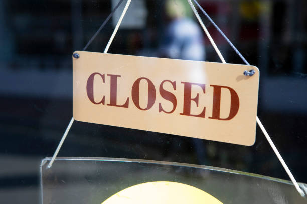 istock Closed sign in a shop door window 2180913613