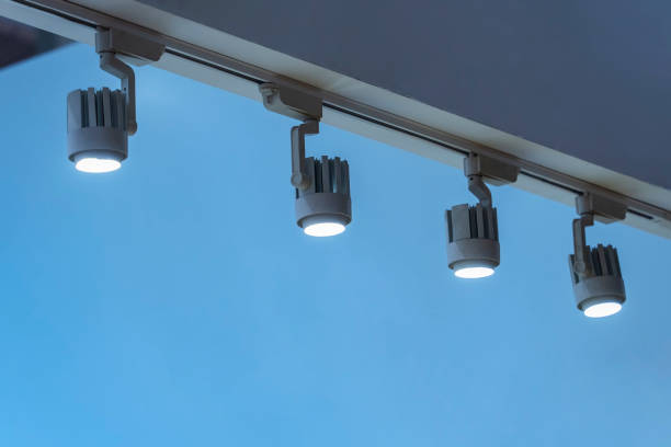 istock Directional LED lights on rails under the ceiling in a modern warehouse, shopping center building, office or other commercial real estate object. 2180914286