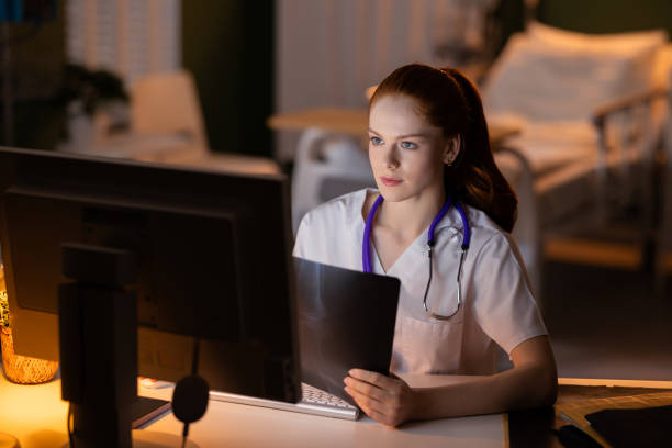 istock Doctor with stethoscope reviewing X-ray and patient data on computer screen 2180916882