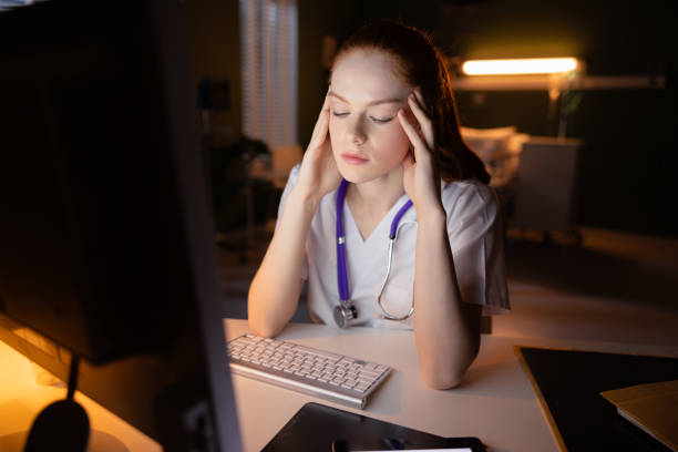 istock Doctor typing on computer, reviewing patient data in hospital 2180917499
