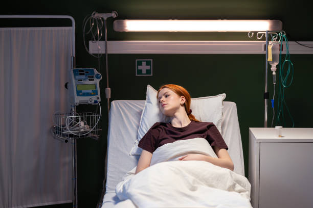 istock Red-haired patient peacefully rests in her hospital bed 2180917541