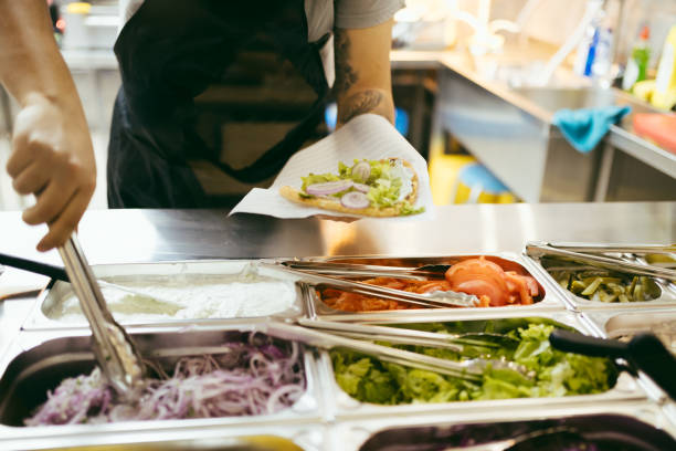 istock Finishing up gyro pita with salads 2180921704