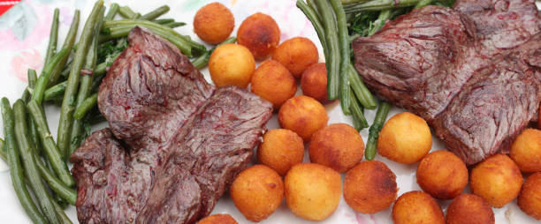 Tab Fried beef served with fried potato balls and green beans