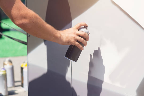 istock Man doing graffiti, holding spray can with hand. Spray aerosol paint for graffiti 2180927394