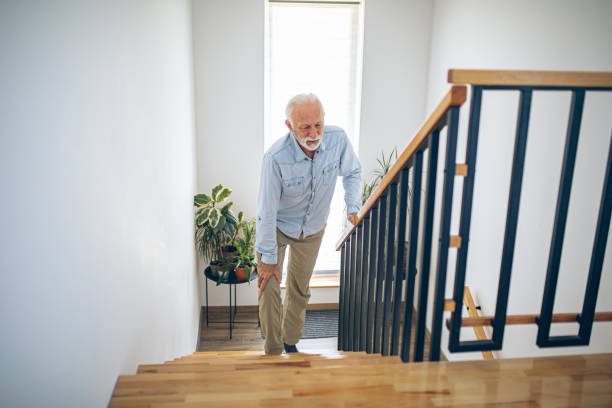 istock Senior man climbing on stairs with pain on knee 2180927621