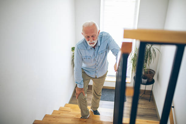 istock Senior man climbing on stairs with pain on knee 2180927667