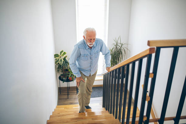 istock Senior man climbing on stairs with pain on knee 2180927711