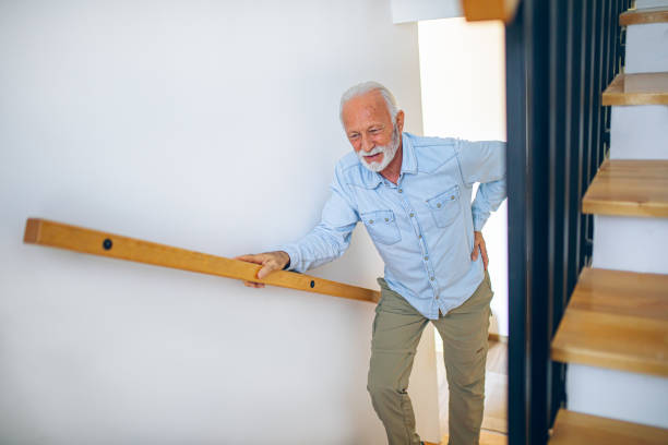 istock Senior man climbing on stairs with pain in his back 2180927744