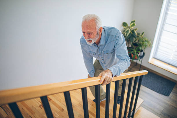 istock Senior man climbing on stairs with pain on knee 2180927768